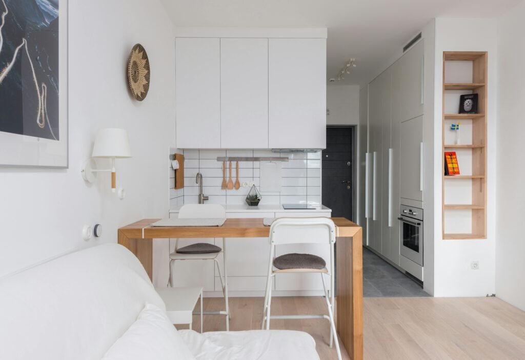 A cozy minimalist apartment interior with modern kitchen and living space.